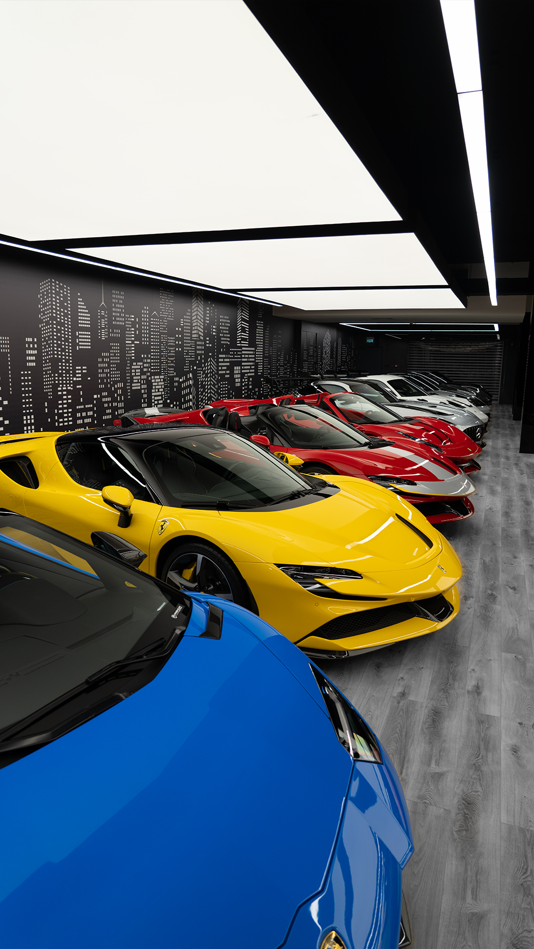 Yellow and blue supercars lined up inside Premium Motors